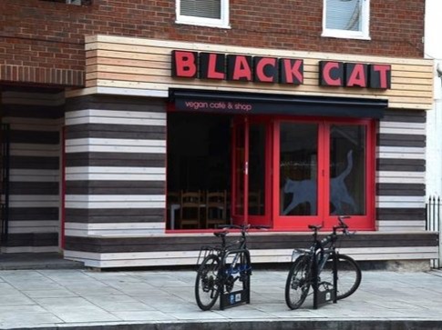 Black Cat Cafe Think junk food isn't for vegans? Think again. Hackney's Black Cat Cafes will bring you the likes of fish and chips, burgers, curries and milkshakes. ...